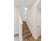 Staircase with wood steps, white risers and railings leading to the upper level at 10302 Pearson Ave, Orlando, FL 32827