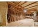 Exposed attic with insulation, ventilation duct, wooden beams, and subflooring at 1042 Sugarloaf Key Loop, Lady Lake, FL 32159