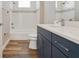 Modern bathroom features a blue vanity, white quartz countertop and stylish subway tile backsplash at 1042 Sugarloaf Key Loop, Lady Lake, FL 32159