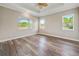 Bedroom boasting plank floors, tray ceiling, and multiple windows for natural light at 1042 Sugarloaf Key Loop, Lady Lake, FL 32159