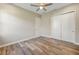 Bedroom with modern ceiling fan, wood-look floors and a closet with sliding doors at 1042 Sugarloaf Key Loop, Lady Lake, FL 32159