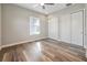 Bedroom with modern ceiling fan, wood-look floors and a closet with sliding doors at 1042 Sugarloaf Key Loop, Lady Lake, FL 32159