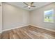 Bright bedroom features modern ceiling fan, wood-look floors and natural light from the window at 1042 Sugarloaf Key Loop, Lady Lake, FL 32159