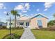 Inviting single-story home boasts a charming porch and well-kept front yard landscaping at 1042 Sugarloaf Key Loop, Lady Lake, FL 32159