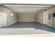 Clean, empty garage with epoxy flooring and two doors at 1042 Sugarloaf Key Loop, Lady Lake, FL 32159
