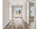 Hallway with wood flooring, neutral walls, and front door view at 1042 Sugarloaf Key Loop, Lady Lake, FL 32159
