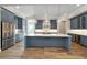 Open kitchen with an island, stainless steel appliances, and modern lighting at 1042 Sugarloaf Key Loop, Lady Lake, FL 32159