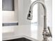Close-up of a modern kitchen faucet with a sleek design against a clean countertop at 1042 Sugarloaf Key Loop, Lady Lake, FL 32159