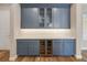A butler's pantry with blue cabinets, a wine cooler, and white quartz countertop, ideal for kitchen storage and entertaining at 1042 Sugarloaf Key Loop, Lady Lake, FL 32159