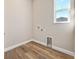 Bright laundry room with wood-look flooring and convenient hookups and connections at 1042 Sugarloaf Key Loop, Lady Lake, FL 32159
