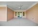 Spacious screened in porch with a ceiling fan and view of the landscaped backyard at 1042 Sugarloaf Key Loop, Lady Lake, FL 32159