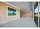 View of the spacious screened in porch with white ceiling and a view of the backyard at 1042 Sugarloaf Key Loop, Lady Lake, FL 32159