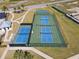 Aerial view of the community recreational courts for basketball and pickleball, perfect for active lifestyles at 1042 Sugarloaf Key Loop, Lady Lake, FL 32159