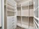 Walk-in closet featuring custom shelves and drawer built-ins for organized storage and style at 1042 Sugarloaf Key Loop, Lady Lake, FL 32159