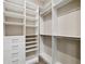 Walk-in closet featuring custom shelves and drawer built-ins for organized storage and style at 1042 Sugarloaf Key Loop, Lady Lake, FL 32159