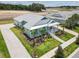 A charming home with lush green grass, beautiful landscaping and inviting porch at 1057 Sugarloaf Key Loop, Lady Lake, FL 32159