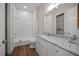 Bright bathroom with granite counters, white cabinets, tub and updated fixtures at 1057 Sugarloaf Key Loop, Lady Lake, FL 32159
