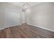 Bright bedroom featuring wood-look flooring, ceiling fan, and a spacious closet with panel doors at 1057 Sugarloaf Key Loop, Lady Lake, FL 32159