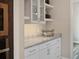 Bright butlers pantry featuring white cabinets, modern hardware and a granite countertop at 1057 Sugarloaf Key Loop, Lady Lake, FL 32159