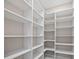 Spacious walk-in closet with custom white shelving and ample storage space at 1057 Sugarloaf Key Loop, Lady Lake, FL 32159