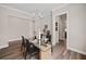Dining room featuring a chandelier, a modern table with seating for six, and dark wood flooring at 1057 Sugarloaf Key Loop, Lady Lake, FL 32159
