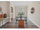 Dining room featuring a chandelier, a modern table with six chairs, and dark wood flooring at 1057 Sugarloaf Key Loop, Lady Lake, FL 32159