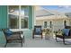 Inviting covered front porch with comfortable seating to enjoy the outdoors at 1057 Sugarloaf Key Loop, Lady Lake, FL 32159