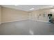 Bright garage with speckled epoxy flooring, utility closet, and attached water heater at 1057 Sugarloaf Key Loop, Lady Lake, FL 32159