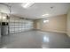 Spacious garage with an epoxy floor, utility closet, and an insulated garage door at 1057 Sugarloaf Key Loop, Lady Lake, FL 32159