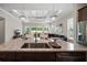 Kitchen island with granite countertop, stainless sink, and view into the living room at 1057 Sugarloaf Key Loop, Lady Lake, FL 32159