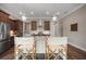 Kitchen island with granite countertops, modern lighting, and breakfast bar seating for casual dining at 1057 Sugarloaf Key Loop, Lady Lake, FL 32159