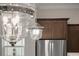 Elegant kitchen lighting fixture complements the stainless steel appliances and wood cabinetry at 1057 Sugarloaf Key Loop, Lady Lake, FL 32159