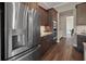 Kitchen featuring stainless steel refrigerator and dark wood cabinets at 1057 Sugarloaf Key Loop, Lady Lake, FL 32159