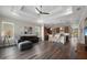 Spacious open living space features hardwood floors connecting the living room to the kitchen area at 1057 Sugarloaf Key Loop, Lady Lake, FL 32159
