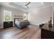 Large main bedroom with trey ceilings, wood floors, and natural light from two windows at 1057 Sugarloaf Key Loop, Lady Lake, FL 32159