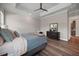Bright main bedroom featuring tray ceilings, wood-look floors and view to the kitchen at 1057 Sugarloaf Key Loop, Lady Lake, FL 32159