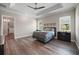 Large main bedroom with trey ceilings, wood floors, and walk in closet at 1057 Sugarloaf Key Loop, Lady Lake, FL 32159