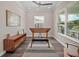 Office with wood floors, modern ceiling fan, large window with view of neighborhood at 1057 Sugarloaf Key Loop, Lady Lake, FL 32159