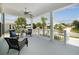Inviting front porch with seating, ceiling fan, and white pillars, perfect for relaxing outside at 1057 Sugarloaf Key Loop, Lady Lake, FL 32159