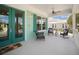 Charming front porch featuring comfortable seating, a ceiling fan, and welcoming exterior at 1057 Sugarloaf Key Loop, Lady Lake, FL 32159