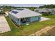 An aerial view of the back of a single-Gathering home, featuring a patio and well-maintained lawn at 1057 Sugarloaf Key Loop, Lady Lake, FL 32159