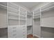 Well-organized walk-in closet with white shelving, drawers, and wooden floors offers ample storage at 1057 Sugarloaf Key Loop, Lady Lake, FL 32159