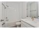 Bright bathroom features white subway tile, modern vanity with white countertop, and a shower-over-tub combination at 1065 Peebles St, Orlando, FL 32827