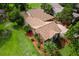 Aerial view of the home showing the roof, mature landscaping, and surrounding greenery at 112 Waterwood Dr, Yalaha, FL 34797