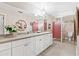 Clean bathroom featuring double sinks, neutral color walls, and white cabinetry at 112 Waterwood Dr, Yalaha, FL 34797