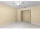 This carpeted bedroom features a ceiling fan and a closet with folding doors at 112 Waterwood Dr, Yalaha, FL 34797