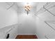 Walk-in closet with custom shelving, lighting, and hardwood floors at 112 Waterwood Dr, Yalaha, FL 34797