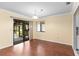 Bright dining area boasts hardwood floors, a sliding glass door to the porch, and crown molding at 112 Waterwood Dr, Yalaha, FL 34797