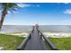 Picturesque view of a private dock leading to the water, creating a tranquil and inviting waterfront experience at 112 Waterwood Dr, Yalaha, FL 34797