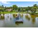 Waterfront dock with covered seating and an American flag waving in the breeze at 112 Waterwood Dr, Yalaha, FL 34797